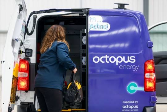 An employee loading tools onto an Octopus Energy van